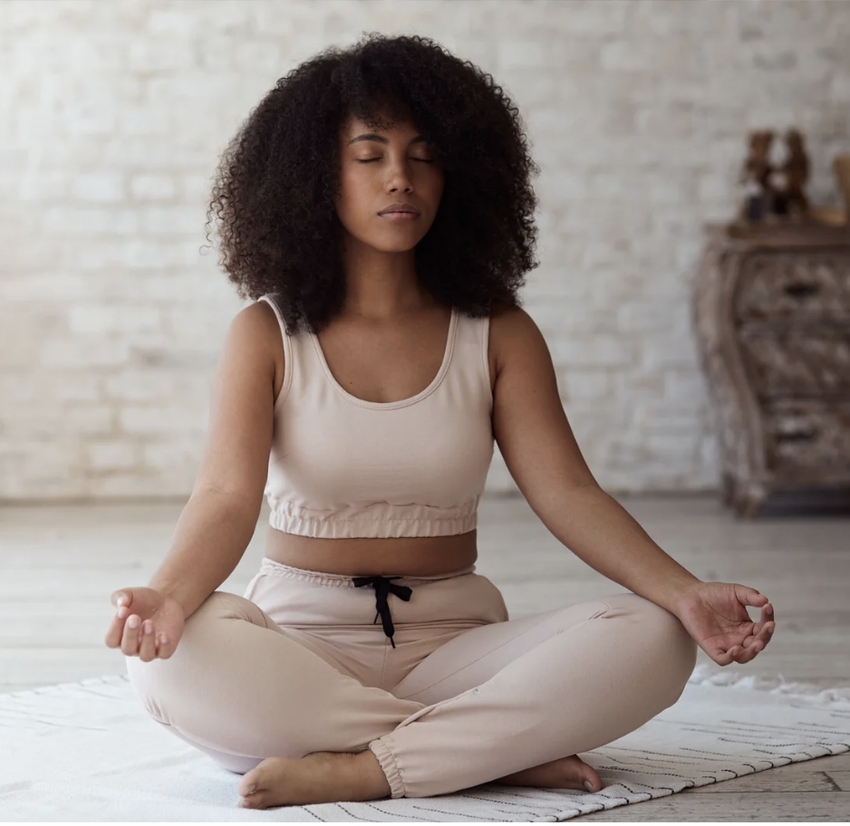 Woman practicing mindful breathing and meditation, reflecting the grounding effects of conscious connected breathwork.